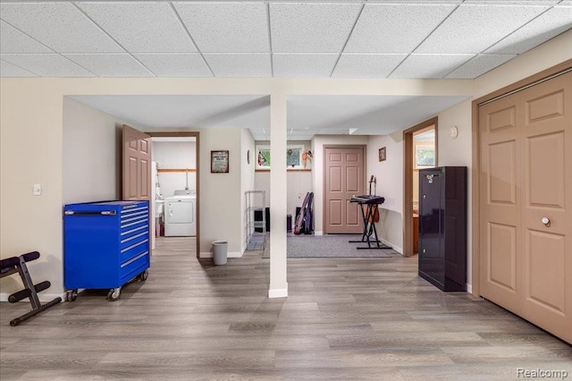 14165 Crampton Rd, Camden, MI 49232 - exercise room featuring wood finished floors, washing machine and clothes dryer, and a drop ceiling