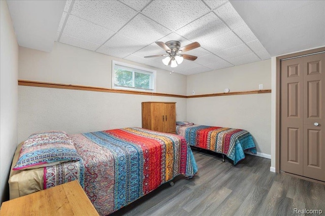 14165 Crampton Rd, Camden, MI 49232 - bedroom with wood finished floors, a drop ceiling, and a ceiling fan