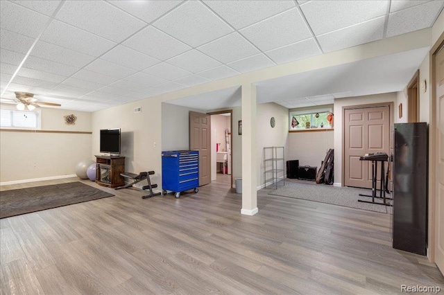 14165 Crampton Rd, Camden, MI 49232 - below grade area with a drop ceiling, wood finished floors, and ceiling fan