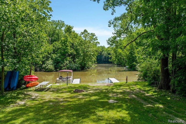 14165 Crampton Rd, Camden, MI 49232 - view of grassy yard featuring a boat dock, an outdoor fire pit, and a water view