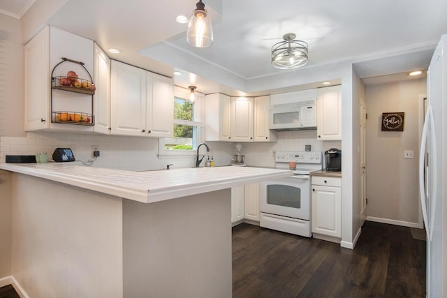 1848 Forest Park Rd, Norton Shores, MI 49441 - kitchen featuring white appliances, a peninsula, white cabinetry, dark wood finished floors, and recessed lighting