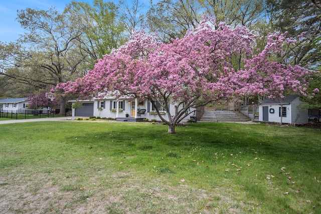 1848 Forest Park Rd, Norton Shores, MI 49441 - view of property hidden behind natural elements with an attached garage, driveway, and an outdoor structure