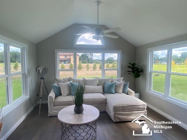 8260 Grande Lake Cir, Temperance, MI 48182 - living area with healthy amount of natural light, ceiling fan, lofted ceiling, and wood finished floors