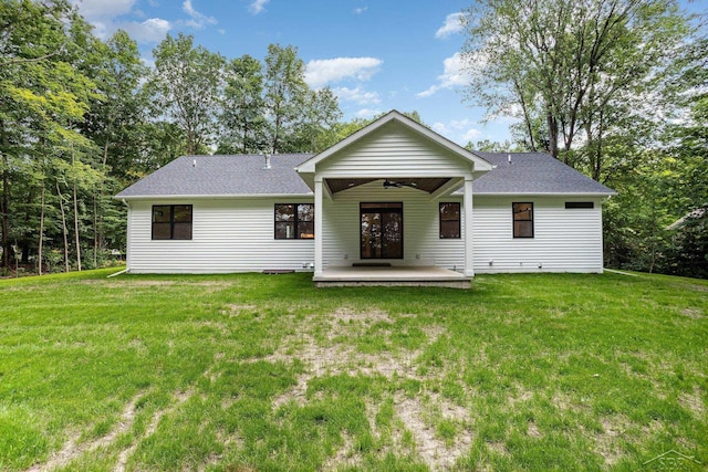 9841 Beech Tree Ln, Frankenmuth, MI 48734 - rear view of house with a lawn, ceiling fan, and roof with shingles