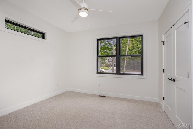 9841 Beech Tree Ln, Frankenmuth, MI 48734 - unfurnished bedroom with light colored carpet and a ceiling fan