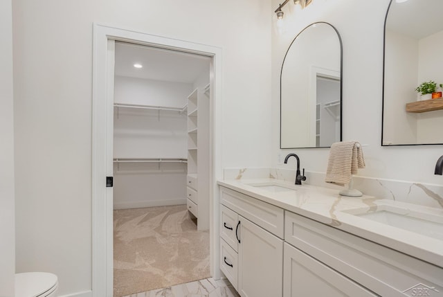 9841 Beech Tree Ln, Frankenmuth, MI 48734 - full bathroom featuring double vanity, a spacious closet, and marble finish flooring