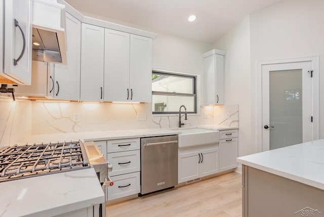 9841 Beech Tree Ln, Frankenmuth, MI 48734 - kitchen featuring appliances with stainless steel finishes, decorative backsplash, light wood-style flooring, white cabinets, and light stone countertops