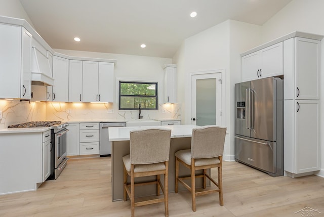 9841 Beech Tree Ln, Frankenmuth, MI 48734 - kitchen featuring high end appliances, light wood finished floors, backsplash, light countertops, and recessed lighting
