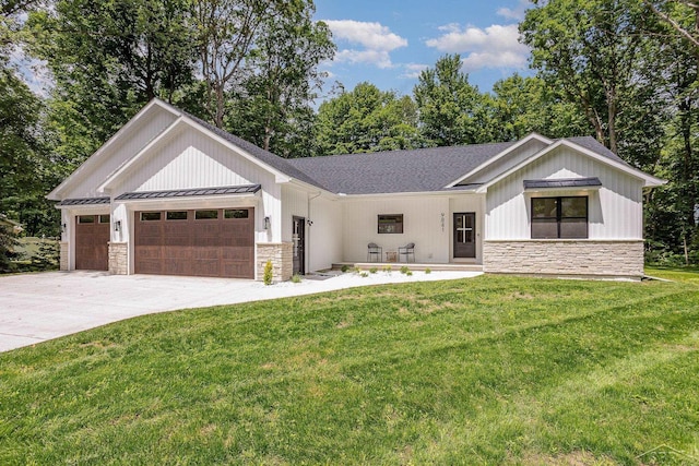 9841 Beech Tree Ln, Frankenmuth, MI 48734 - modern farmhouse with stone siding, a garage, a front yard, driveway, and a standing seam roof