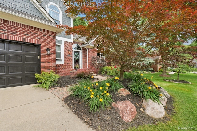 678 Twin Oaks Ct, Rochester Hills, MI 48307 - view of exterior entry featuring brick siding and a yard