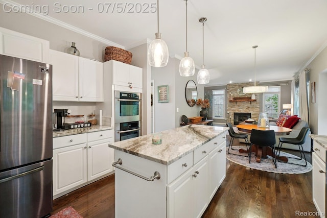 678 Twin Oaks Ct, Rochester Hills, MI 48307 - kitchen with stainless steel appliances, crown molding, dark wood-style floors, a stone fireplace, and a kitchen island