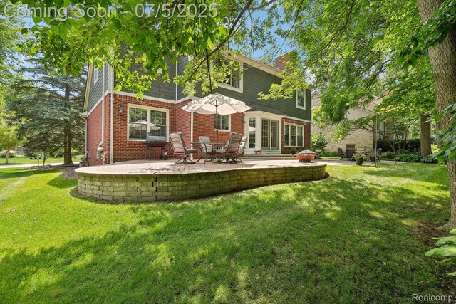 678 Twin Oaks Ct, Rochester Hills, MI 48307 - rear view of property featuring brick siding, a yard, a patio area, and a chimney