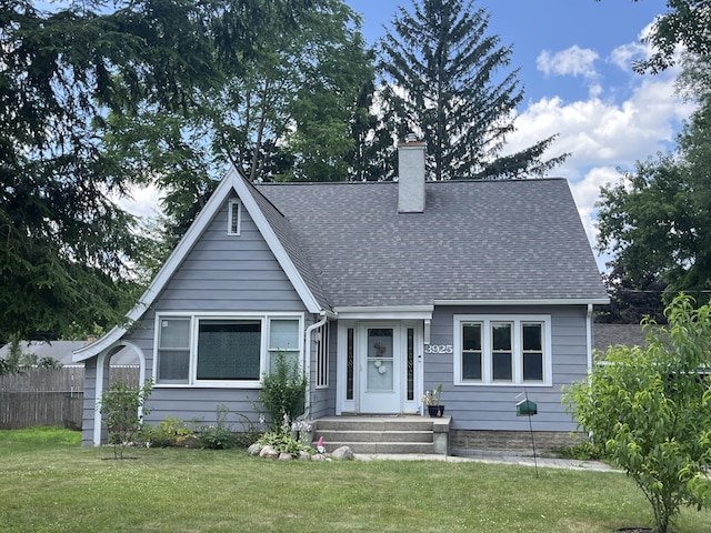 3925 Miramar Ave NE, Grand Rapids, MI 49525 - view of front facade with roof with shingles and a chimney