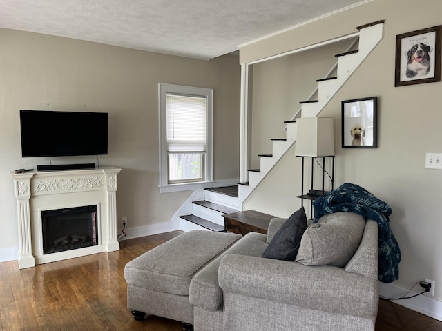 3925 Miramar Ave NE, Grand Rapids, MI 49525 - living area with stairs, wood finished floors, a textured ceiling, and a fireplace