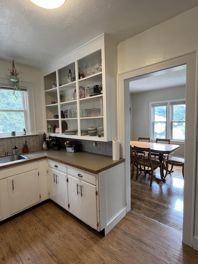 3925 Miramar Ave NE, Grand Rapids, MI 49525 - kitchen featuring open shelves, dark wood-type flooring, white cabinetry, a textured ceiling, and dark countertops