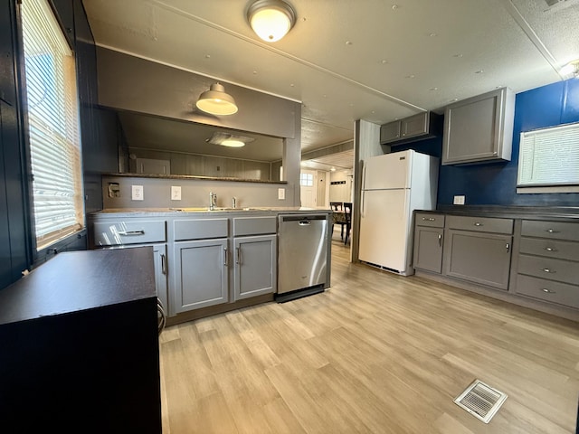 333 E Lakewood Blvd Unit 315, Holland, MI 49424 - kitchen featuring dishwasher, freestanding refrigerator, gray cabinets, and light wood-style flooring