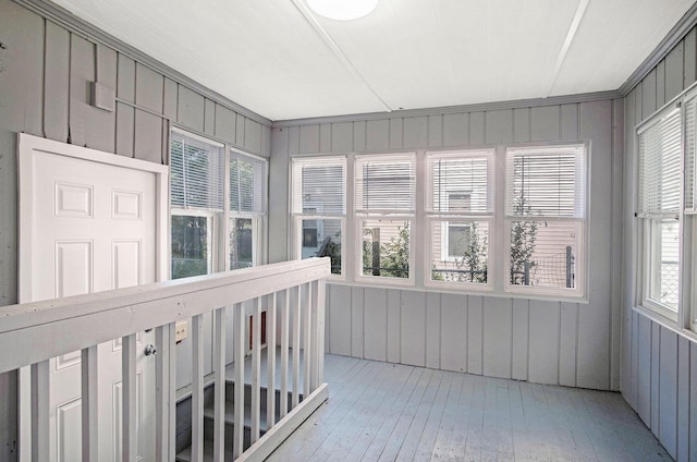 816 Oakhill St SE, Grand Rapids, MI 49507 - unfurnished sunroom with wood-type flooring and wood walls