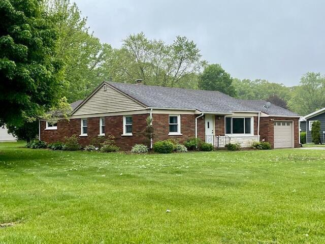 6828 First Ave, Coloma, MI 49038 - ranch-style house featuring an attached garage, a front yard, and brick siding