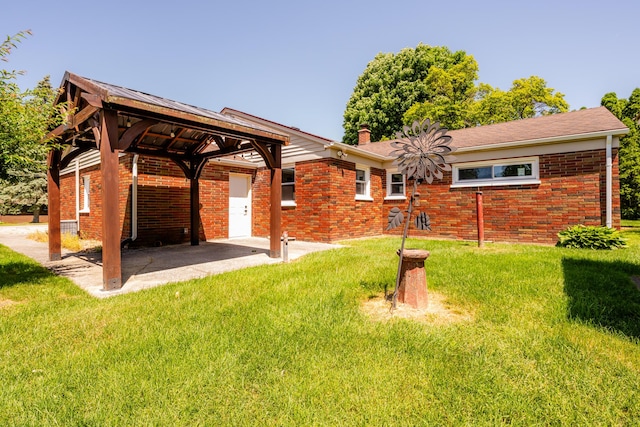 6828 First Ave, Coloma, MI 49038 - rear view of house with brick siding, a lawn, a gazebo, a patio area, and a chimney