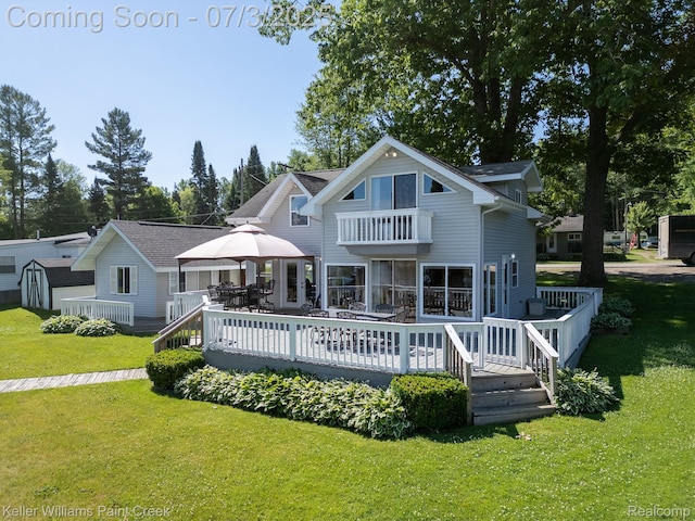 1379 Sioux St, Gladwin, MI 48624 - back of house featuring a balcony, a lawn, a gazebo, and a wooden deck