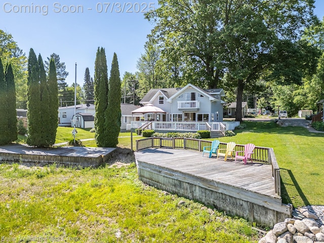1379 Sioux St, Gladwin, MI 48624 - rear view of house featuring a wooden deck and a yard