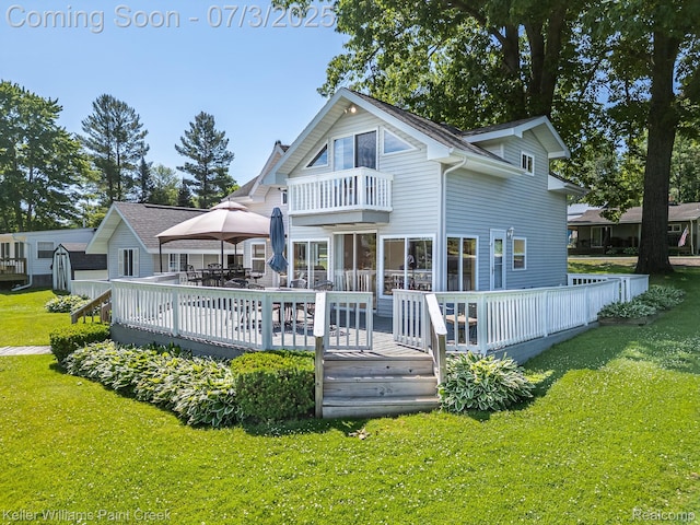 1379 Sioux St, Gladwin, MI 48624 - back of house featuring a balcony, a lawn, a deck, and outdoor dining area