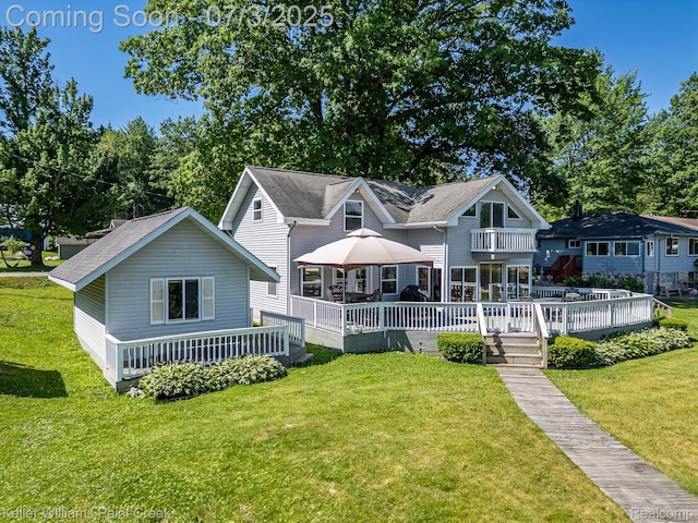 1379 Sioux St, Gladwin, MI 48624 - rear view of house featuring a deck, a yard, and roof with shingles