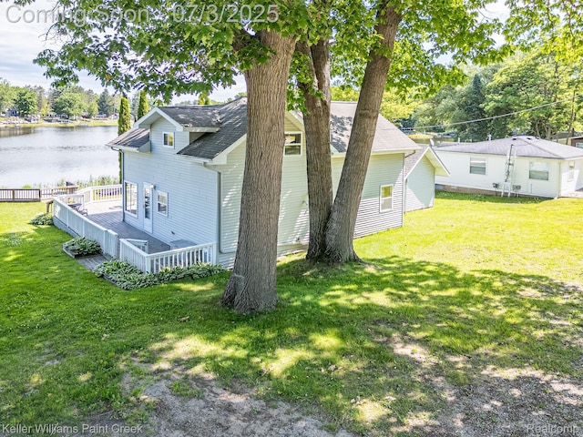 1379 Sioux St, Gladwin, MI 48624 - view of property exterior with a lawn and a deck with water view