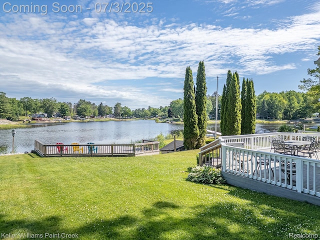 1379 Sioux St, Gladwin, MI 48624 - view of green lawn featuring a deck with water view