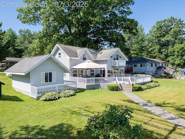 1379 Sioux St, Gladwin, MI 48624 - back of house featuring a wooden deck, a lawn, roof with shingles, and a balcony