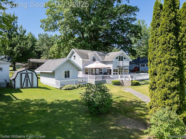 1379 Sioux St, Gladwin, MI 48624 - back of property with a storage shed, a lawn, and a wooden deck