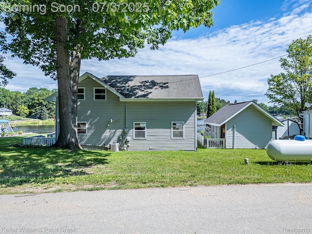 1379 Sioux St, Gladwin, MI 48624 - view of side of home with a shingled roof