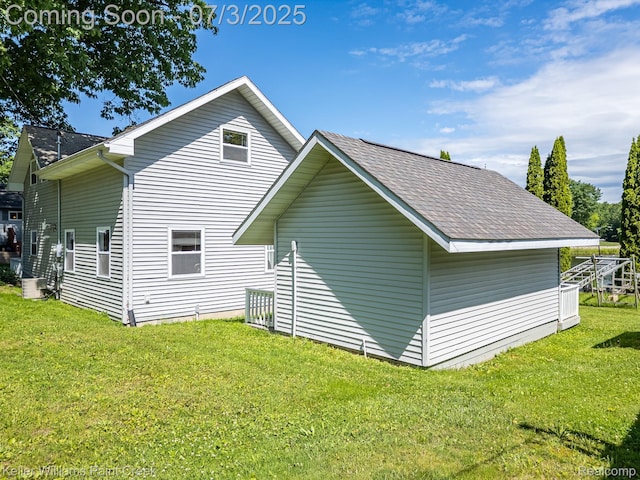1379 Sioux St, Gladwin, MI 48624 - view of property exterior with a yard and a shingled roof
