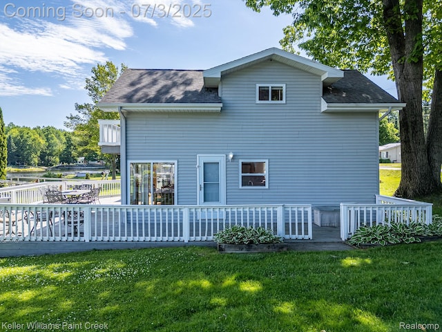 1379 Sioux St, Gladwin, MI 48624 - rear view of property featuring a yard, a deck, and a shingled roof