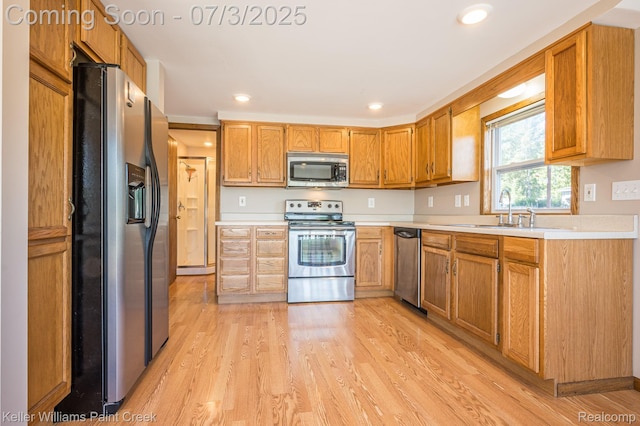 1379 Sioux St, Gladwin, MI 48624 - kitchen with appliances with stainless steel finishes, light countertops, light wood-style flooring, and recessed lighting