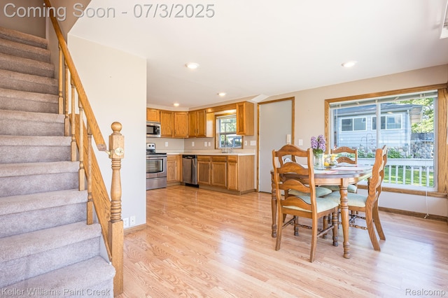 1379 Sioux St, Gladwin, MI 48624 - dining room with light wood-style flooring, stairway, and recessed lighting