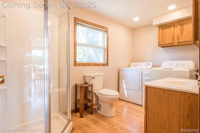 1379 Sioux St, Gladwin, MI 48624 - full bathroom with independent washer and dryer, wood finished floors, a stall shower, and vanity