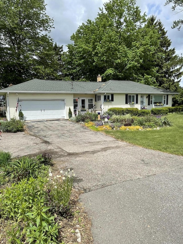 8441 Homerich Ave, Byron Center, MI 49315 - ranch-style house with asphalt driveway, an attached garage, a chimney, and a front lawn