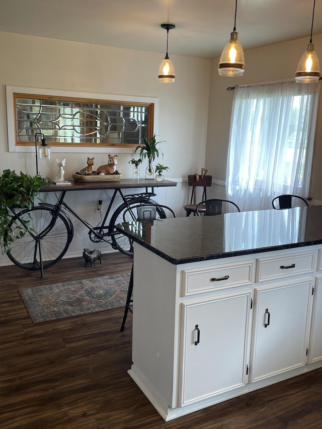 8441 Homerich Ave, Byron Center, MI 49315 - kitchen featuring dark wood-type flooring, white cabinetry, and pendant lighting