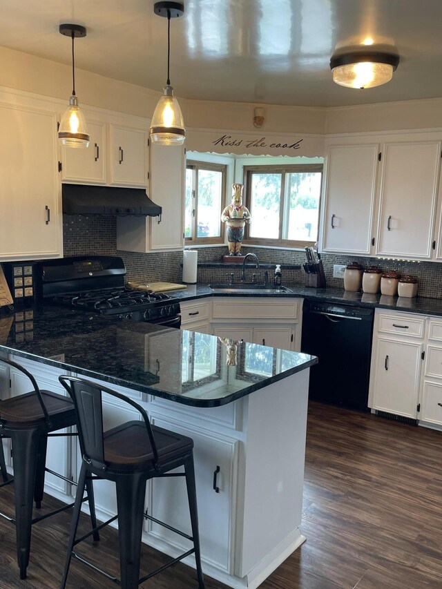 8441 Homerich Ave, Byron Center, MI 49315 - kitchen with black appliances, under cabinet range hood, white cabinetry, tasteful backsplash, and decorative light fixtures
