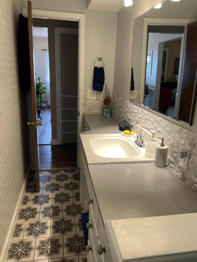 8441 Homerich Ave, Byron Center, MI 49315 - bathroom featuring vanity, wallpapered walls, and decorative backsplash