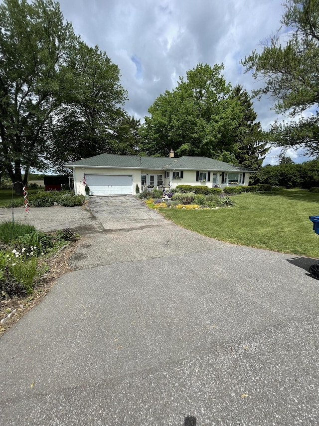 8441 Homerich Ave, Byron Center, MI 49315 - ranch-style home with an attached garage, driveway, and a front lawn