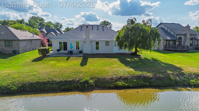 52448 Cedar Mill Dr, Macomb, MI 48042 - rear view of property with a patio area, a lawn, and a water view