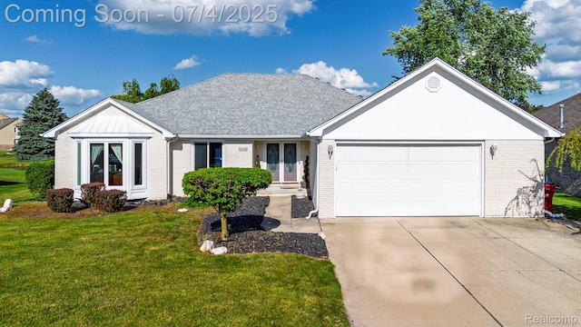 52448 Cedar Mill Dr, Macomb, MI 48042 - view of front of home with brick siding, french doors, a front yard, a garage, and driveway