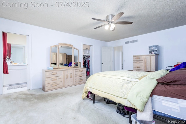 52448 Cedar Mill Dr, Macomb, MI 48042 - carpeted bedroom featuring a spacious closet, connected bathroom, ceiling fan, a closet, and a textured ceiling