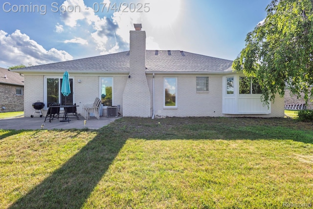 52448 Cedar Mill Dr, Macomb, MI 48042 - rear view of property featuring a patio, a chimney, brick siding, and a lawn
