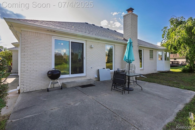 52448 Cedar Mill Dr, Macomb, MI 48042 - rear view of property with a chimney, a patio, brick siding, and a shingled roof