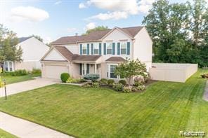 44569 Greenbriar Ct St, Van Buren, MI 48111 - traditional-style house with concrete driveway, a garage, and a front yard