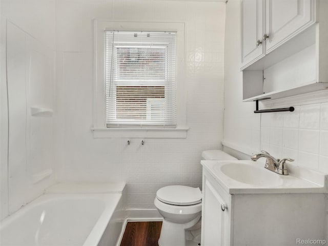 12667 Lauder St, Detroit, MI 48227 - bathroom featuring tile walls, vanity, tasteful backsplash, and wood finished floors