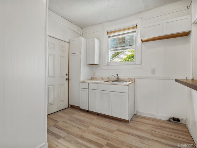 12667 Lauder St, Detroit, MI 48227 - kitchen with light wood-style flooring, light countertops, and white cabinetry